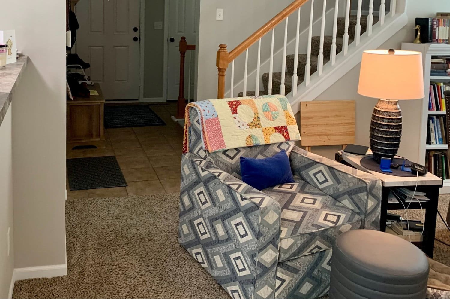 Living room and entryway before — old carpet and tile