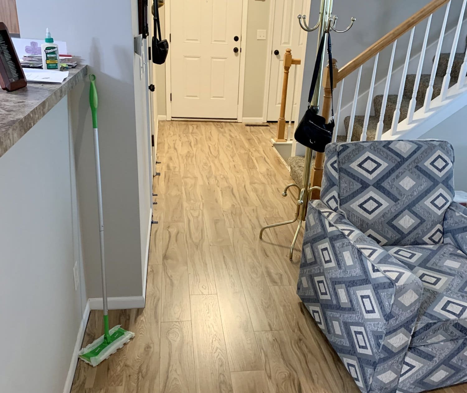 Living room and entryway after — new luxury vinyl plank flooring